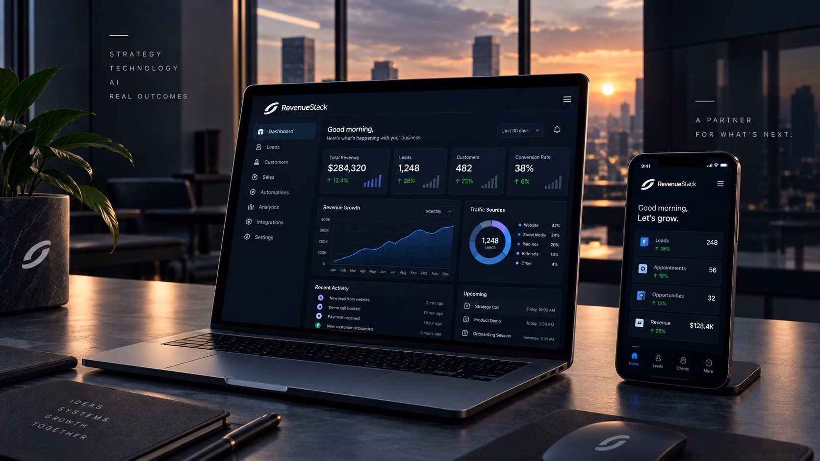 A laptop and phone showing RevenueStack dashboards on a desk at sunset